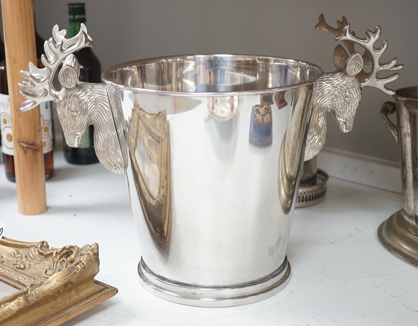 A collection of silver plated and metalware comprising two wine coolers, a tankard and a coaster, largest 29cm high. Condition - fair to good